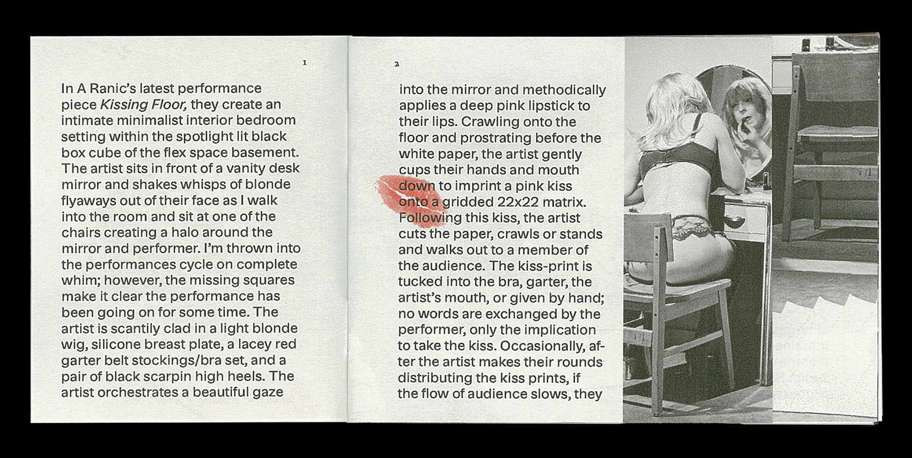 first page of A Ranic Kissing Floor zine, featuring a black and white image of a drag woman applying lipstick in front of a mirror on the right. The pages feature black text printed on cool grey paper with a transparent kiss in red printed over the text in the center right page.