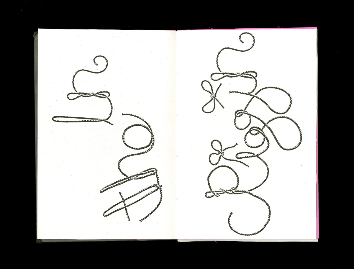 open book spread displaying the word 'in the' and 'riggin' in a typeface made of rope on the left annd right pages, respectively, on a white paper