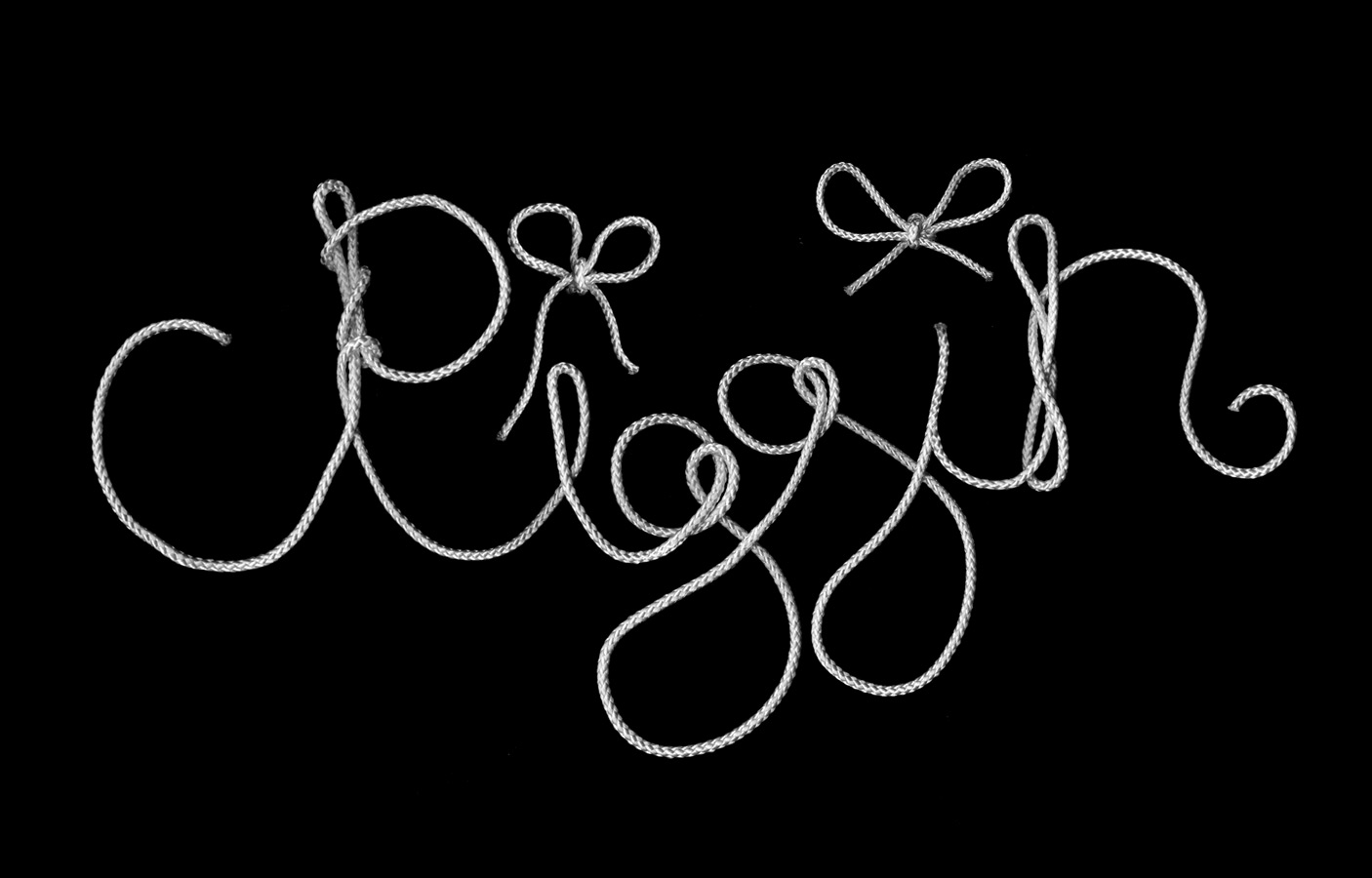 black and white scan of rope spelling out 'ridder' made out of rope in a cursive script